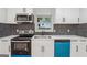 Remodeled kitchen with stainless appliances, modern backsplash, and bright blue dishwasher at 4443 Flat Shoals, Decatur, GA 30034