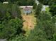 Aerial view of the home showcasing a large, wooded lot and proximity to nearby streets and neighborhood at 10038 Hemlock Way, Jonesboro, GA 30238