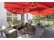 Outdoor deck with comfortable seating, patio umbrella, and wooded views at 10038 Hemlock Way, Jonesboro, GA 30238