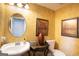 Elegant half bathroom with stylish mirror, sink, and ornate decor at 10038 Hemlock Way, Jonesboro, GA 30238