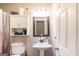 Functional bathroom with a vanity, toilet, and storage cabinet, providing convenience and organization at 10038 Hemlock Way, Jonesboro, GA 30238