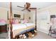 Charming bedroom with canopy bed, plush pillows, and large window at 10038 Hemlock Way, Jonesboro, GA 30238
