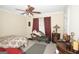 Cozy bedroom featuring a floral bedspread and comfortable seating area at 10038 Hemlock Way, Jonesboro, GA 30238