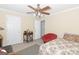 Bright bedroom with floral bedspread and round chair, with two doors at 10038 Hemlock Way, Jonesboro, GA 30238