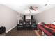 Finished bonus room with seating, projector screen and dark vinyl floors at 10038 Hemlock Way, Jonesboro, GA 30238