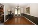 Formal dining room with wainscoting, hardwood floors, and chandelier, perfect for hosting gatherings at 10038 Hemlock Way, Jonesboro, GA 30238