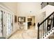 Spacious home foyer featuring tile floors, beautiful stairway and high ceilings, and modern decor at 10038 Hemlock Way, Jonesboro, GA 30238