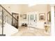 Bright foyer features neutral paint, tile floor, decorative front door, and staircase at 10038 Hemlock Way, Jonesboro, GA 30238