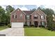 Beautiful brick home with a well-manicured lawn, featuring a two-car garage and elegant front entrance at 10038 Hemlock Way, Jonesboro, GA 30238