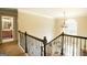 Elegant hallway with decorative railing and chandelier, leading to other rooms at 10038 Hemlock Way, Jonesboro, GA 30238