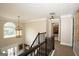 Elegant hallway with decorative lighting, crown molding, and a window with a view at 10038 Hemlock Way, Jonesboro, GA 30238