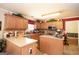 Well-lit kitchen features wooden cabinetry, tiled backsplash and ample counter space, enhancing its functionality at 10038 Hemlock Way, Jonesboro, GA 30238