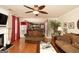 Cozy living room features hardwood floors, ceiling fan, and a view into the home's kitchen at 10038 Hemlock Way, Jonesboro, GA 30238