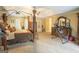Well-lit main bedroom featuring a four-poster bed, seating area, and tasteful decor at 10038 Hemlock Way, Jonesboro, GA 30238
