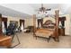Large main bedroom featuring a four-poster bed, seating area, and ample space for relaxation at 10038 Hemlock Way, Jonesboro, GA 30238