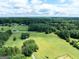 Expansive land with lush greenery and a home with a long driveway surrounded by woods at 1502 Campground, Mcdonough, GA 30252