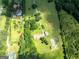 Picturesque aerial view of a sprawling lot with lush greenery and charming home with ample land at 1502 Campground, Mcdonough, GA 30252
