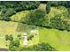Picturesque aerial view of a sprawling lot with lush greenery and charming home with ample land at 1502 Campground, Mcdonough, GA 30252