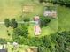 Lush aerial shot of home with well-maintained landscape, surrounded by trees and open fields at 1502 Campground, Mcdonough, GA 30252