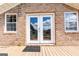 Exterior view of the back entrance, framed by brick walls and a welcome mat, enhancing the inviting atmosphere at 1502 Campground, Mcdonough, GA 30252