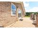 Exterior view of the house showcasing a brick facade, expansive deck, and well-maintained outdoor space at 1502 Campground, Mcdonough, GA 30252