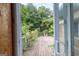 View of the deck and lush backyard greenery from inside the home at 1502 Campground, Mcdonough, GA 30252