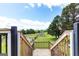 Backyard view from the deck featuring a charming building and lush greenery, creating a tranquil outdoor setting at 1502 Campground, Mcdonough, GA 30252