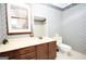 Bathroom featuring wood vanity with sink and patterned wallpaper at 1502 Campground, Mcdonough, GA 30252