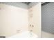 Traditional bathroom with white tub and shower featuring tiled shower surround and vintage fixtures at 1502 Campground, Mcdonough, GA 30252