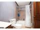 Bathroom featuring a bathtub with shower and striped wallpaper at 1502 Campground, Mcdonough, GA 30252
