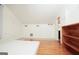Unfurnished bedroom with vaulted ceilings and doorway to another room, showcasing hardwood and tile floors at 1502 Campground, Mcdonough, GA 30252