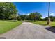 Long driveway leads to a secluded property with lush green lawns and mature trees on a clear day at 1502 Campground, Mcdonough, GA 30252