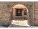 Arched brick doorway leads to the glass-paned front door of this brick home at 1502 Campground, Mcdonough, GA 30252