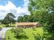 Charming brick home with well-manicured lawn and mature trees creating a peaceful setting at 1502 Campground, Mcdonough, GA 30252