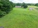 Scenic backyard of brick home with sunroom, patio area, surrounded by lush greenery at 1502 Campground, Mcdonough, GA 30252