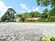 Brick home surrounded by mature trees and beautiful greenery from a low angle at 1502 Campground, Mcdonough, GA 30252
