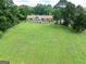 Beautiful backyard view of brick home with sunroom, patio, and lush green lawn at 1502 Campground, Mcdonough, GA 30252