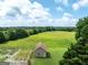 Exterior of a charming brick home with a green field and surrounding trees at 1502 Campground, Mcdonough, GA 30252