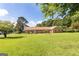 Charming brick ranch home with a sprawling lawn and mature trees at 1502 Campground, Mcdonough, GA 30252
