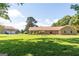 Brick home with detached garage on large lot featuring a vast lawn and mature trees at 1502 Campground, Mcdonough, GA 30252