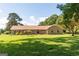 Brick home with a sprawling lawn and mature trees at 1502 Campground, Mcdonough, GA 30252