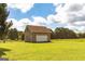 A detached one-car garage with brick veneer and a lush green yard at 1502 Campground, Mcdonough, GA 30252