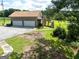 Two-car garage with a spacious driveway and a deck overlooking a large yard and greenery at 1502 Campground, Mcdonough, GA 30252