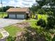 Two-car garage with a spacious driveway and a deck overlooking a large yard and greenery at 1502 Campground, Mcdonough, GA 30252