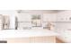 Open kitchen with a large island, stainless steel appliances and all white cabinetry at 1502 Campground, Mcdonough, GA 30252