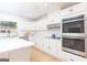 Well-appointed kitchen with white cabinets, stainless steel appliances, and a center island with seating at 1502 Campground, Mcdonough, GA 30252