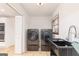 Bright laundry room featuring modern appliances and a utility sink at 1502 Campground, Mcdonough, GA 30252