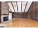 Inviting living room with vaulted ceilings, wood paneling, brick fireplace, and wood burning stove at 1502 Campground, Mcdonough, GA 30252