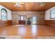Large room with brick feature wall, wood-burning stove, and hardwood floors perfect for gatherings at 1502 Campground, Mcdonough, GA 30252