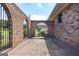 Arched brick wall and metal fence surrounding a brick patio at 1502 Campground, Mcdonough, GA 30252